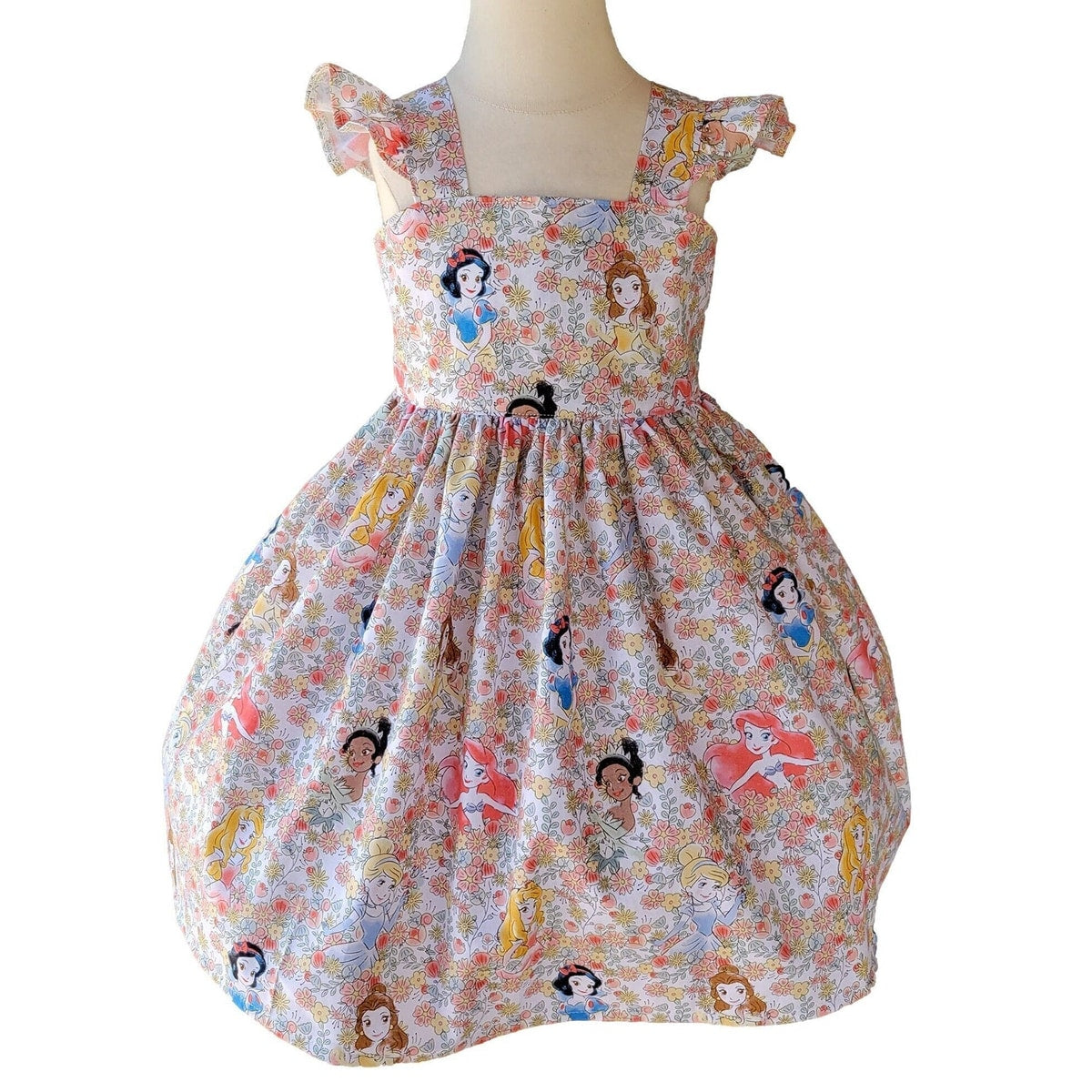 Dress with princesses in a floral pattern on a white background