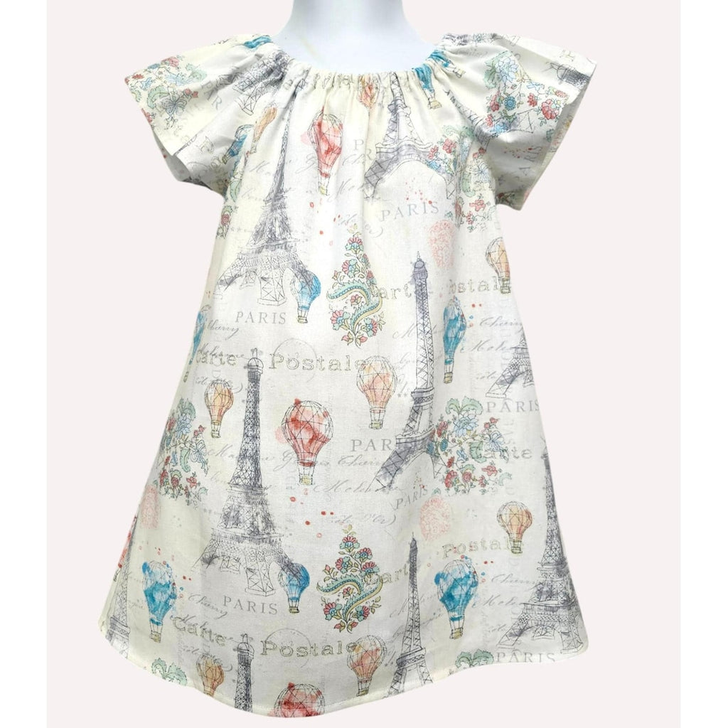 Short-sleeve dress with Paris-themed print on a mannequin against a white background