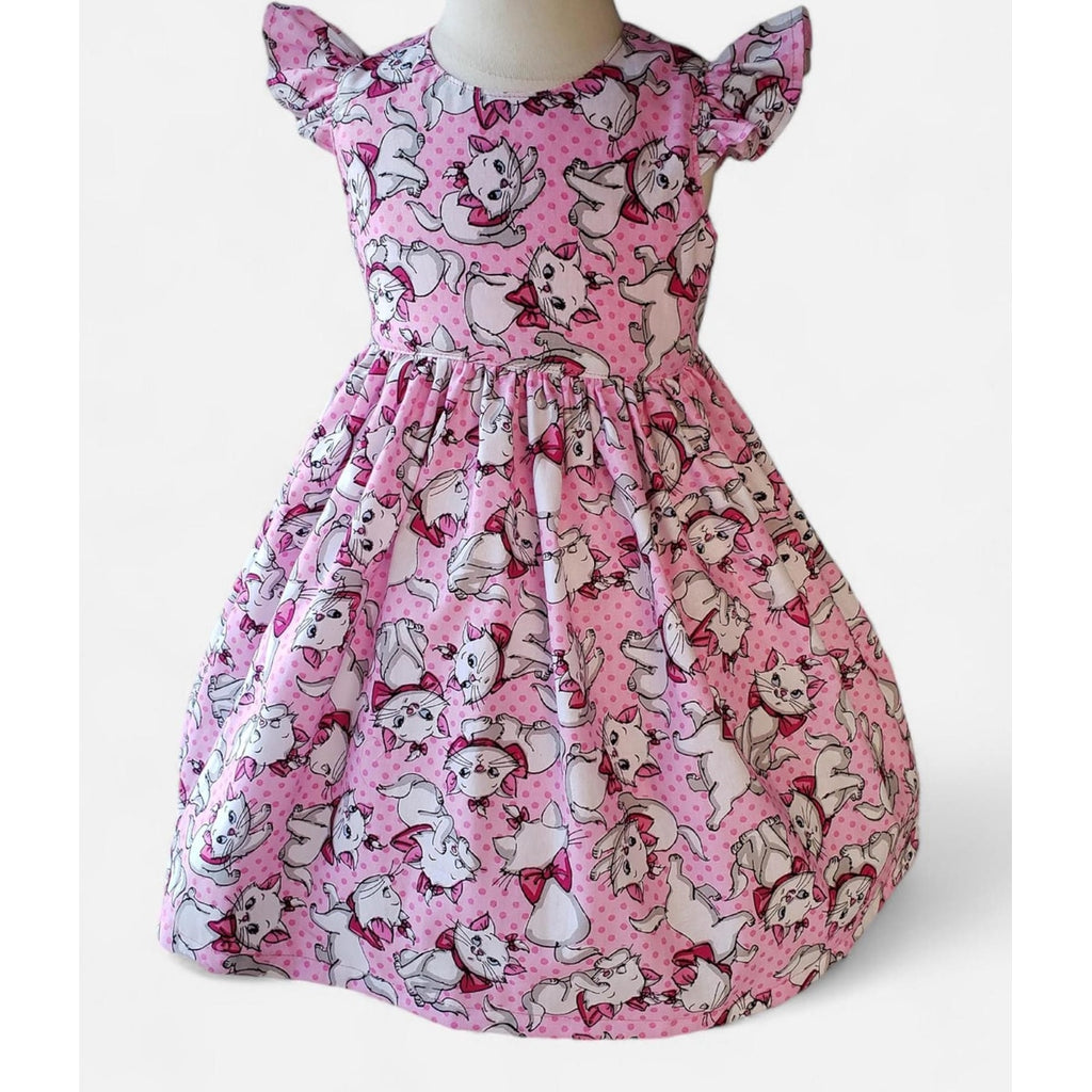 Pink dress with cartoon character pattern on a white background
