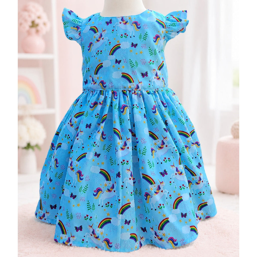 Blue children's dress with unicorn and rainbow patterns on a mannequin.