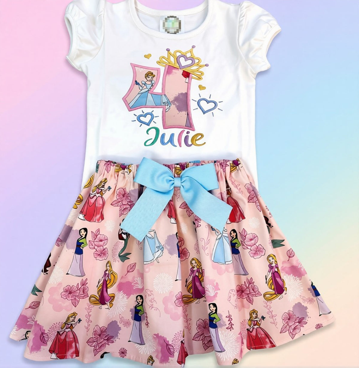 Children's outfit with princess-themed skirt and white top on a colorful background