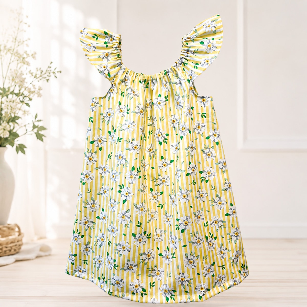 Yellow floral dress with striped pattern on a light background