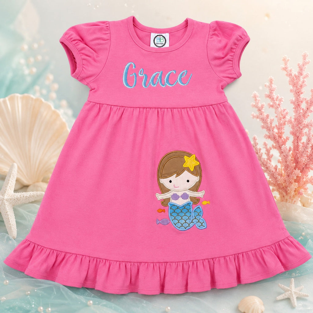 Pink dress with mermaid design and name 'Grace' on a decorative background