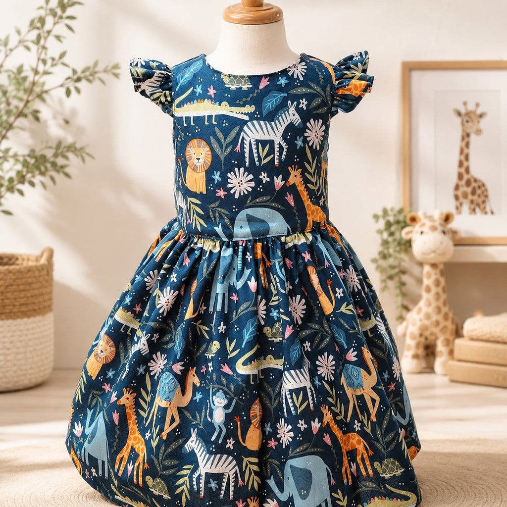 Children's dress with animal pattern on a mannequin against a neutral background