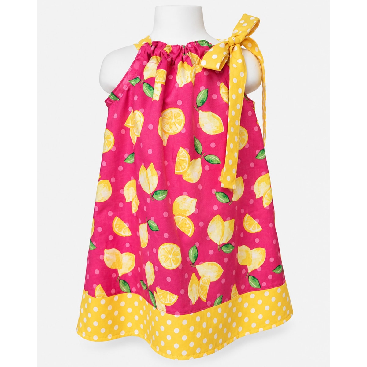 Pink dress with lemon pattern on a mannequin against a white background