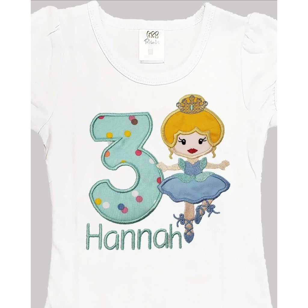 White t-shirt with a design of a fairy and the number 3, on a gray background