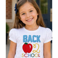 Young girl wearing a 'Back to School' shirt with an apple graphic.